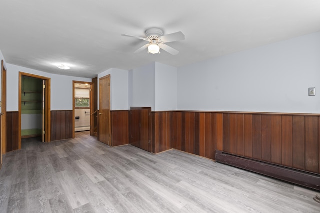 26 Caroldon Rd, Middletown, CT 06457 - unfurnished room featuring wainscoting, a baseboard radiator, baseboard heating, light wood-style flooring, and ceiling fan