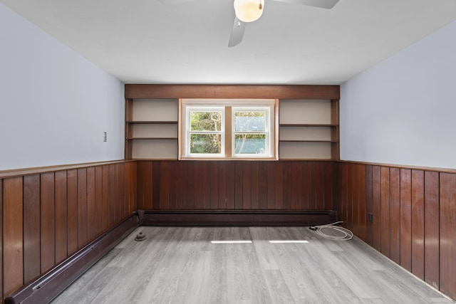 26 Caroldon Rd, Middletown, CT 06457 - unfurnished room featuring a wainscoted wall, wood walls, wood finished floors, ceiling fan, and baseboard heating