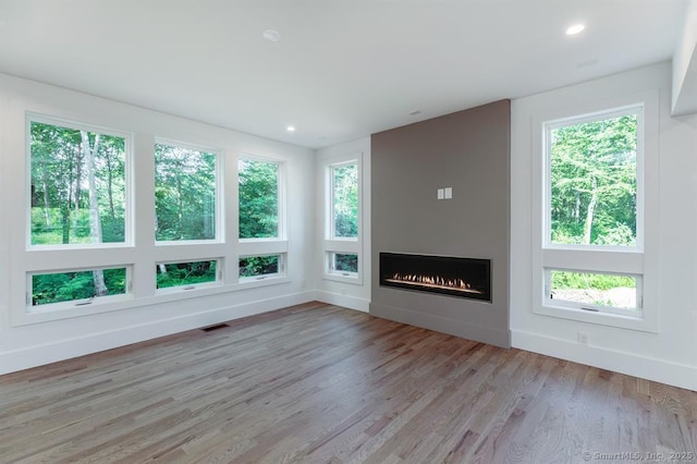 4 Vona Way, Newtown, CT 06470 - unfurnished living room with light wood-type flooring, healthy amount of natural light, a fireplace, and recessed lighting