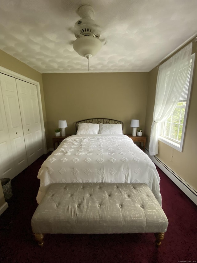 29 Meadowbrook Dr, Brooklyn, CT 06234 - bedroom featuring dark colored carpet, baseboards, baseboard heating, a closet, and a ceiling fan