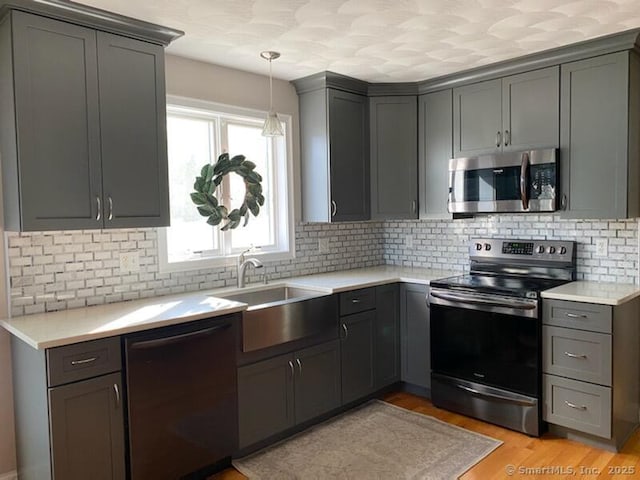 29 Meadowbrook Dr, Brooklyn, CT 06234 - kitchen with stainless steel appliances, gray cabinetry, light wood-style floors, and tasteful backsplash