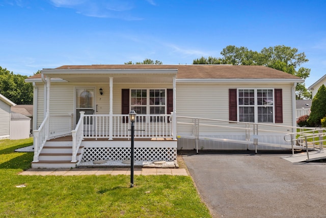 7 Rose Ct, East Windsor, CT 06088 - view of front of house featuring covered porch, roof with shingles, and a front yard