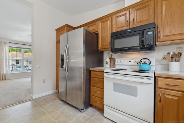 7 Rose Ct, East Windsor, CT 06088 - kitchen with black microwave, white electric stove, stainless steel refrigerator with ice dispenser, and light countertops