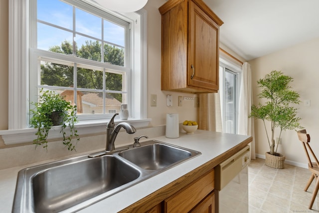7 Rose Ct, East Windsor, CT 06088 - kitchen featuring a sink, dishwasher, healthy amount of natural light, and brown cabinetry