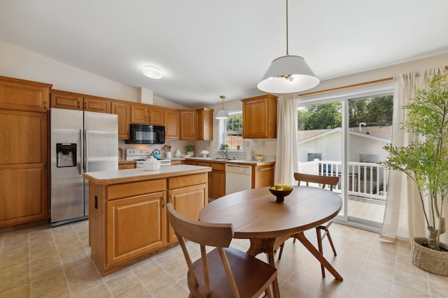 7 Rose Ct, East Windsor, CT 06088 - kitchen featuring white appliances, light countertops, lofted ceiling, a kitchen island, and decorative light fixtures