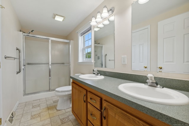 7 Rose Ct, East Windsor, CT 06088 - bathroom featuring a stall shower, double vanity, toilet, and stone finish flooring