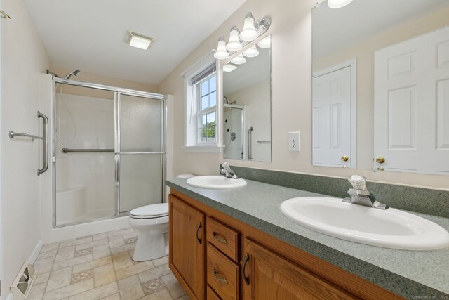 7 Rose Ct, East Windsor, CT 06088 - full bath with a shower stall, double vanity, toilet, and stone finish floors