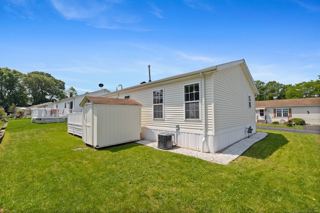 7 Rose Ct, East Windsor, CT 06088 - back of property with central AC unit, a yard, and a wooden deck