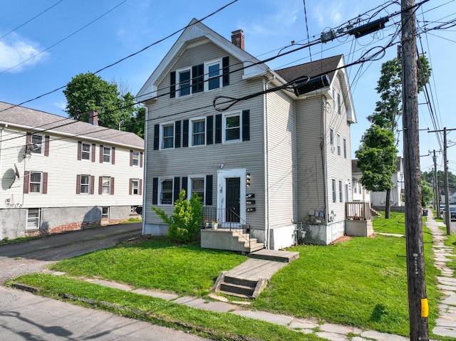 24 N St, Meriden, CT 06451 - view of front of house featuring a chimney and a front yard