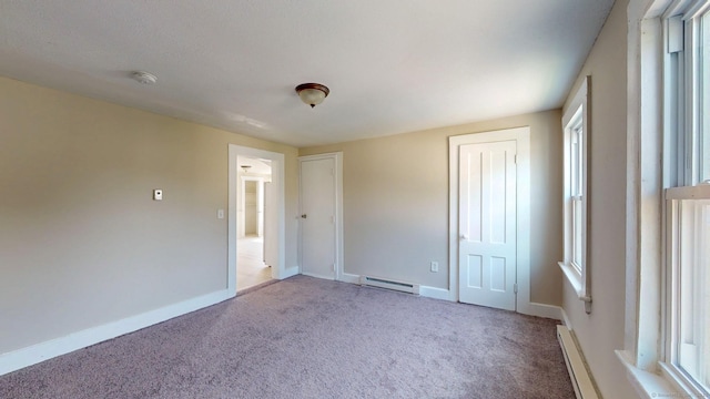 24 N St, Meriden, CT 06451 - unfurnished bedroom with a baseboard heating unit, carpet flooring, two closets, and baseboards
