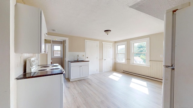 24 N St, Meriden, CT 06451 - kitchen with a sink, a baseboard radiator, white appliances, healthy amount of natural light, and a textured ceiling