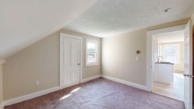 24 N St, Meriden, CT 06451 - bonus room with carpet floors, baseboards, a textured ceiling, a baseboard radiator, and a sink