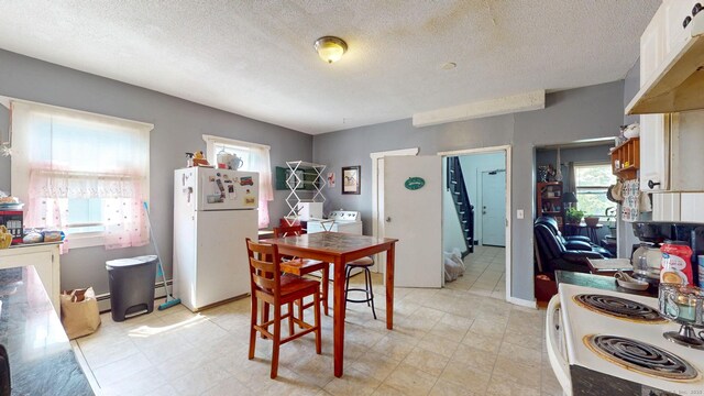 24 N St, Meriden, CT 06451 - dining space with washer and dryer, baseboard heating, and a textured ceiling