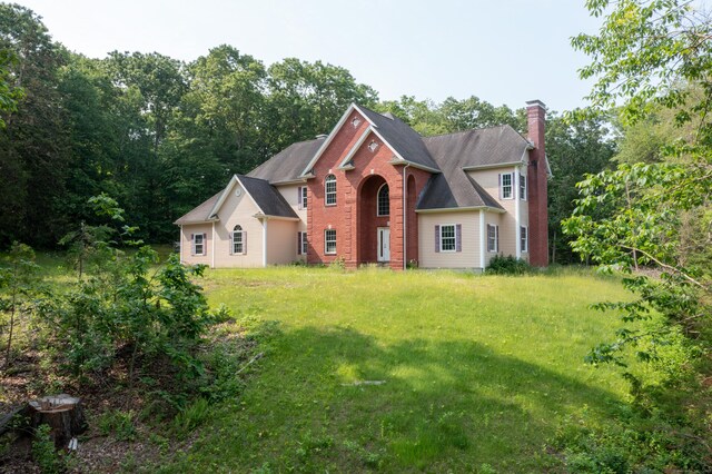 501 Taylor Hill Rd, Griswold, CT 06351 - view of front of home featuring a chimney, a front lawn, and brick siding