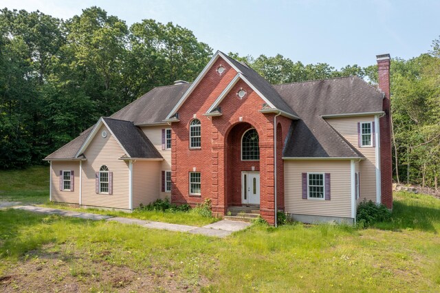 501 Taylor Hill Rd, Griswold, CT 06351 - view of front of home with a chimney, brick siding, and a shingled roof
