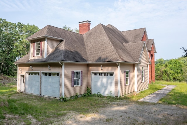 501 Taylor Hill Rd, Griswold, CT 06351 - view of side of property with a chimney, roof with shingles, and driveway