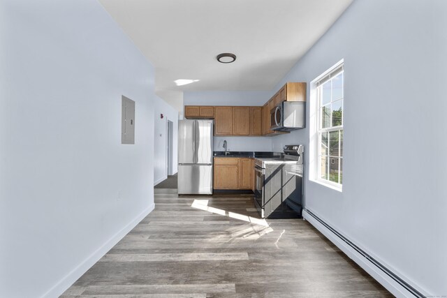 728 Quinnipiac Ave, New Haven, CT 06513 - kitchen featuring stainless steel appliances, a baseboard heating unit, electric panel, wood finished floors, and baseboards