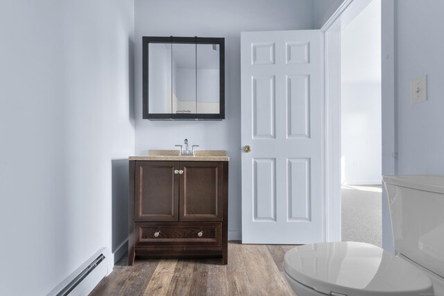 728 Quinnipiac Ave, New Haven, CT 06513 - bathroom featuring baseboard heating, vanity, and wood finished floors