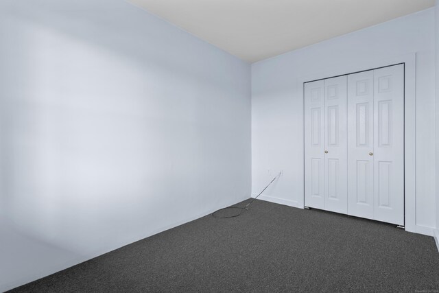 728 Quinnipiac Ave, New Haven, CT 06513 - unfurnished bedroom featuring dark colored carpet and a closet