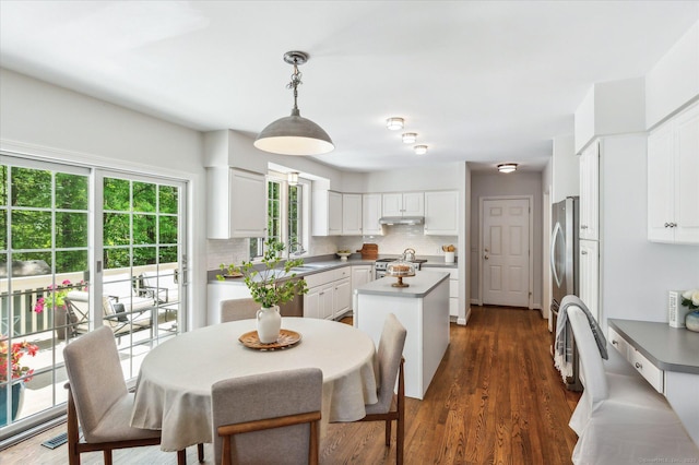 4 Joseph Dr Unit 4, Simsbury, CT 06070 - kitchen with stainless steel appliances, a kitchen island, white cabinets, tasteful backsplash, and a sink