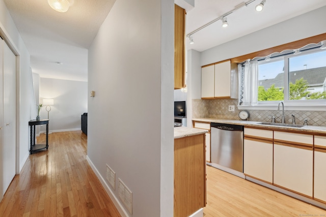 66 Staffordshire Commons Dr Unit 66, Wallingford, CT 06492 - kitchen with dishwasher, light wood finished floors, backsplash, and a sink