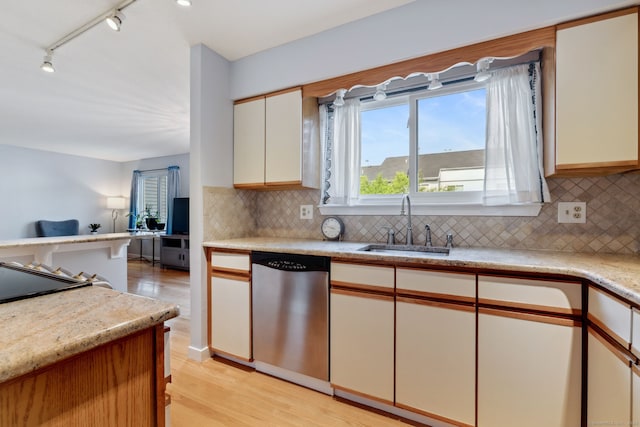 66 Staffordshire Commons Dr Unit 66, Wallingford, CT 06492 - kitchen with stainless steel dishwasher, light wood-style flooring, tasteful backsplash, open floor plan, and a sink