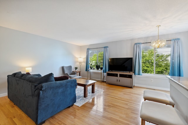 66 Staffordshire Commons Dr Unit 66, Wallingford, CT 06492 - living area with light wood-type flooring, a chandelier, and baseboards
