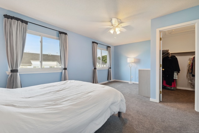66 Staffordshire Commons Dr Unit 66, Wallingford, CT 06492 - carpeted bedroom with a walk in closet, baseboards, a closet, and a ceiling fan