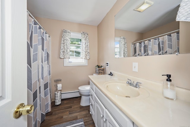 69 Ponham St, Waterbury, CT 06708 - full bath featuring a baseboard radiator, vanity, wood finished floors, and healthy amount of natural light
