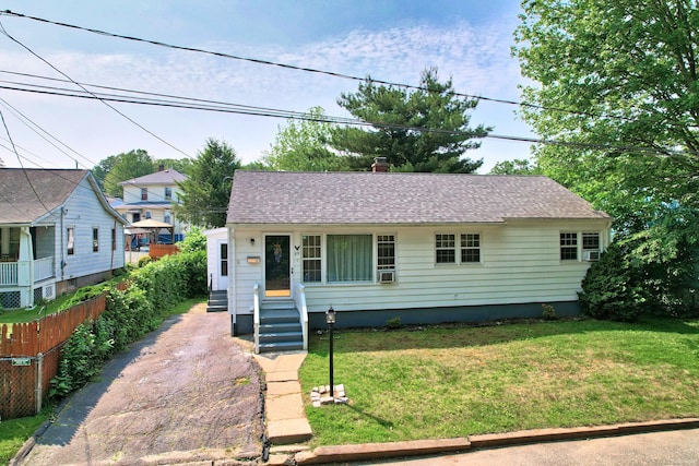69 Ponham St, Waterbury, CT 06708 - view of front facade featuring a shingled roof, a chimney, asphalt driveway, and entry steps