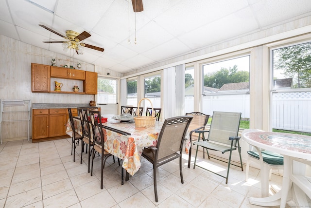 dining room featuring healthy amount of natural light, light tile patterned floors, a ceiling fan, and lofted ceiling