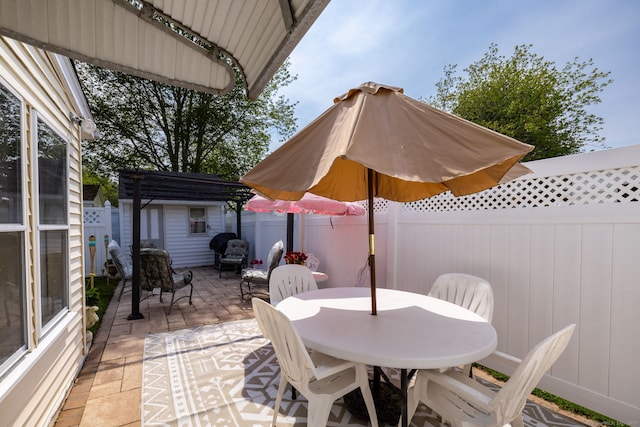 fenced backyard featuring a patio area and outdoor dining space