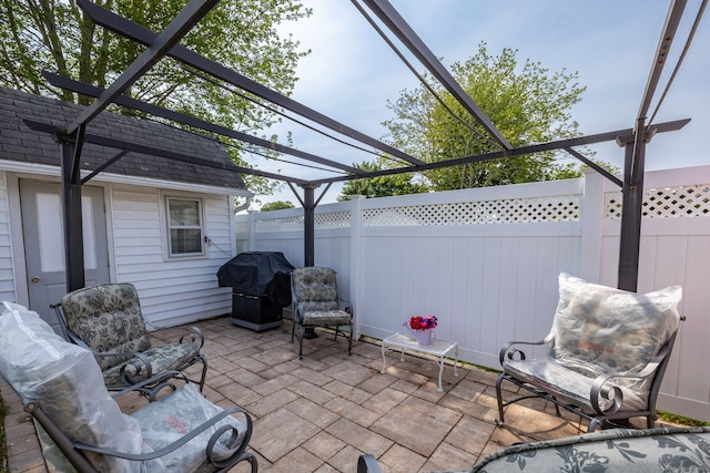 view of patio with grilling area and a pergola