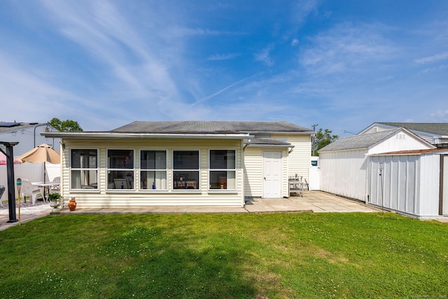 back of property with a patio area and a storage shed