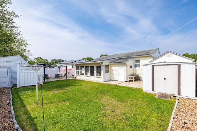 back of property with a patio area, a shed, and a sunroom