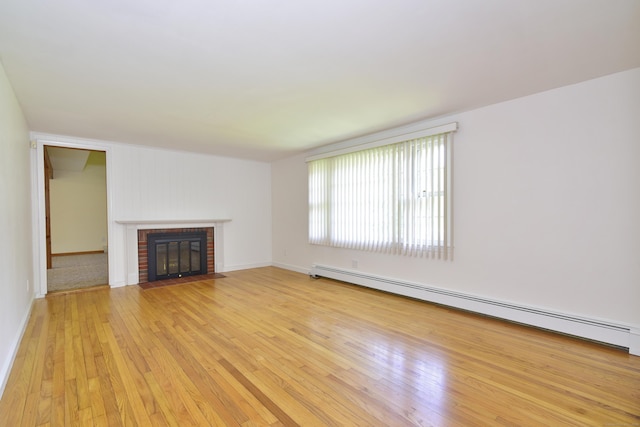118 Putnam Rd, Pomfret, CT 06259 - unfurnished living room featuring a baseboard radiator, a fireplace, light wood-type flooring, and baseboards
