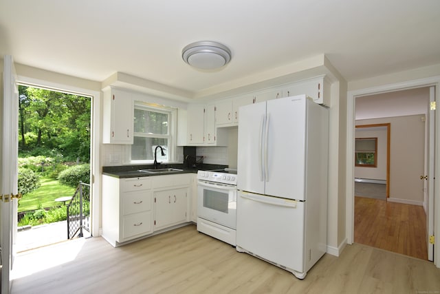 118 Putnam Rd, Pomfret, CT 06259 - kitchen featuring white appliances, a sink, light wood-style floors, dark countertops, and tasteful backsplash