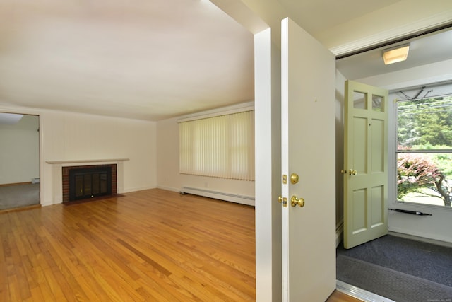 118 Putnam Rd, Pomfret, CT 06259 - unfurnished living room with a baseboard heating unit, wood finished floors, and a fireplace