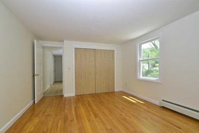 118 Putnam Rd, Pomfret, CT 06259 - unfurnished bedroom featuring baseboard heating, light wood-style floors, a closet, and baseboards