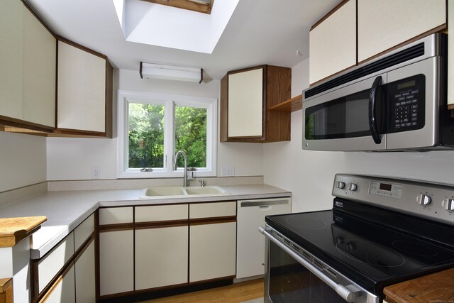 118 Putnam Rd, Pomfret, CT 06259 - kitchen with black electric range, stainless steel microwave, a sink, and light countertops