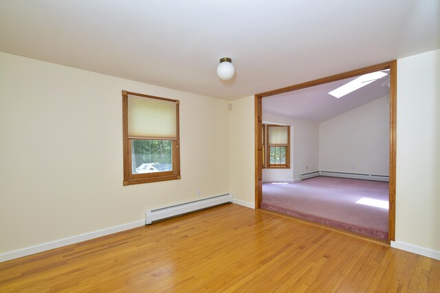 118 Putnam Rd, Pomfret, CT 06259 - empty room with baseboard heating, a skylight, light wood-type flooring, and baseboards
