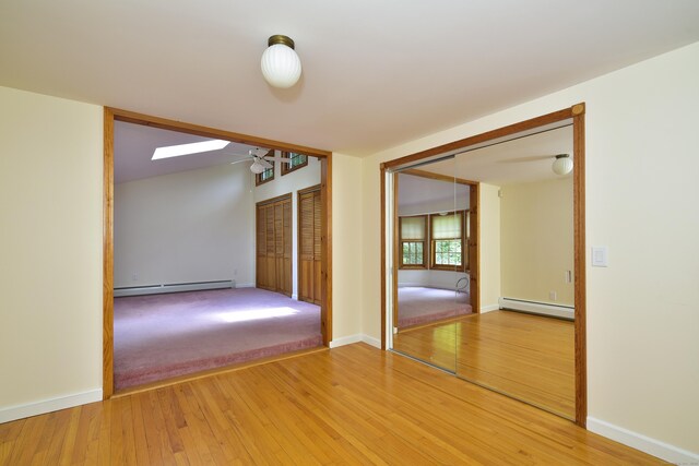 118 Putnam Rd, Pomfret, CT 06259 - unfurnished room with a baseboard heating unit, a ceiling fan, and light wood-type flooring