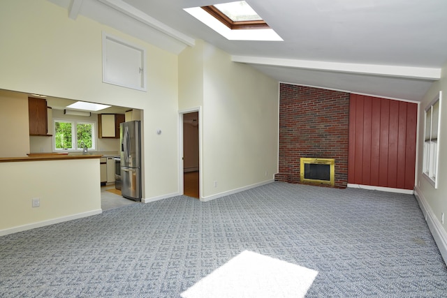 118 Putnam Rd, Pomfret, CT 06259 - unfurnished living room with beam ceiling, light colored carpet, a skylight, a fireplace, and baseboards