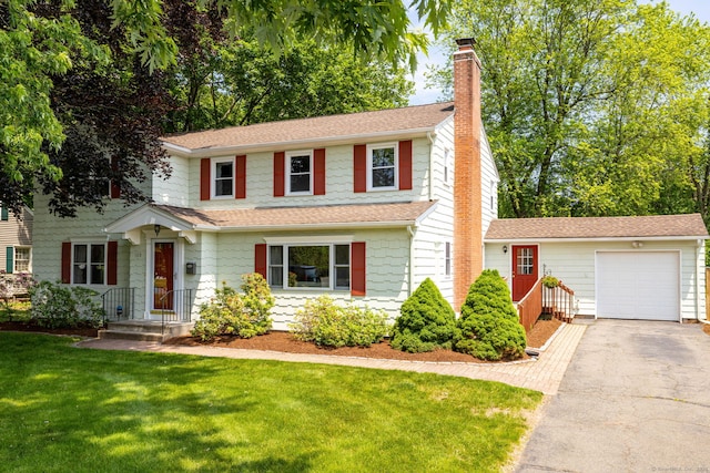 100 Grandview St, Manchester, CT 06040 - traditional-style house with a chimney, asphalt driveway, a garage, a shingled roof, and a front yard