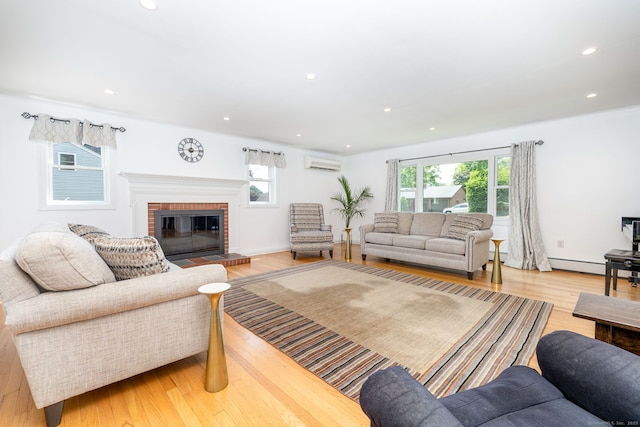 100 Grandview St, Manchester, CT 06040 - living room with an AC wall unit, a brick fireplace, light wood finished floors, a baseboard radiator, and recessed lighting