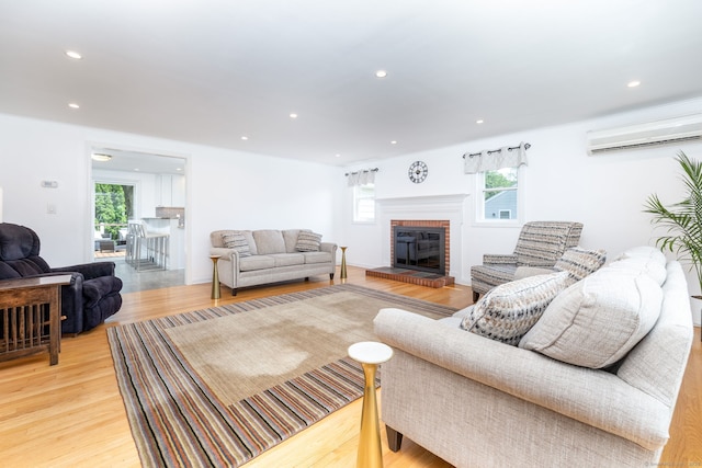 100 Grandview St, Manchester, CT 06040 - living room with a fireplace, light wood finished floors, recessed lighting, and an AC wall unit