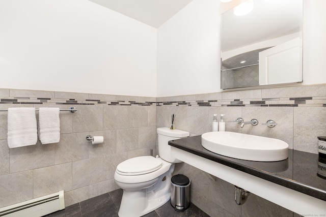 100 Grandview St, Manchester, CT 06040 - bathroom featuring a baseboard heating unit, a sink, toilet, tile walls, and a wainscoted wall