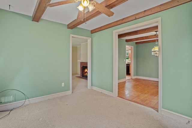 2 Stowe Pl, Trumbull, CT 06611 - unfurnished room featuring beamed ceiling, a ceiling fan, carpet flooring, a brick fireplace, and a chandelier