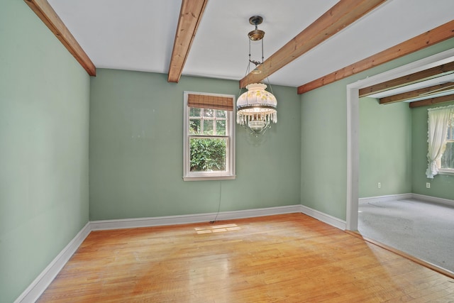 2 Stowe Pl, Trumbull, CT 06611 - empty room featuring plenty of natural light, a chandelier, beam ceiling, and wood finished floors
