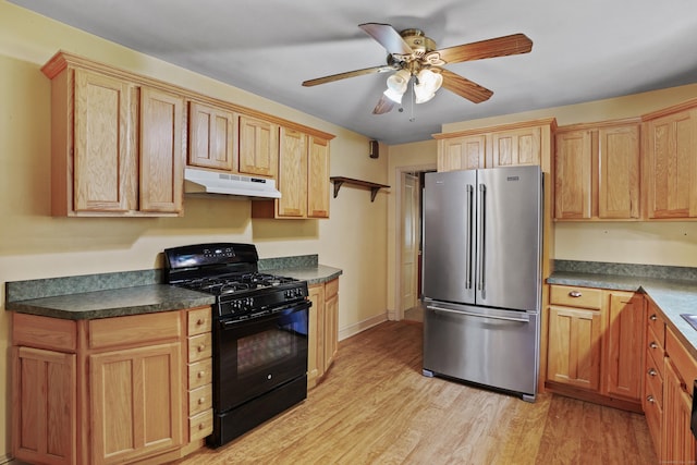 2 Stowe Pl, Trumbull, CT 06611 - kitchen with freestanding refrigerator, black range with gas stovetop, under cabinet range hood, light wood finished floors, and dark countertops